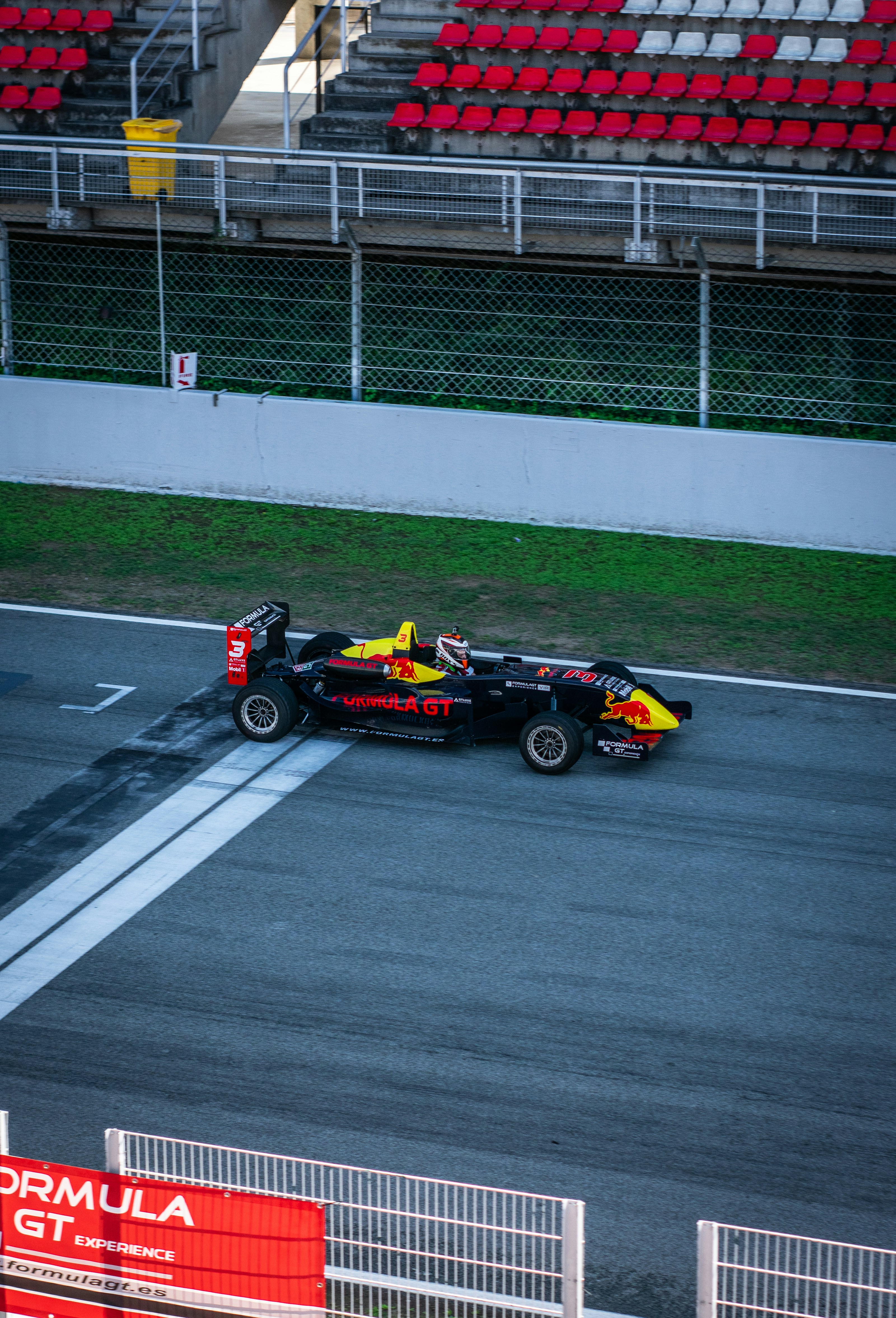 Red F1 race car driving at high speed - Photo by Martí Sierra on Unsplash
